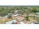 Aerial view of the property showcasing its neighborhood, mature trees, and the house with a new roof at 105 E Magnolia St, Davenport, FL 33837