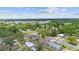 Aerial view of a residential neighborhood with mature trees and well-maintained homes at 105 E Magnolia St, Davenport, FL 33837