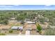 Aerial shot showcasing neighborhood, mature trees, and a newly roofed home at 105 E Magnolia St, Davenport, FL 33837