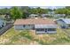 Aerial view of backyard featuring a screened-in porch and fenced perimeter at 105 E Magnolia St, Davenport, FL 33837