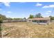 Large backyard with a screened-in porch and fenced perimeter, ideal for outdoor activities at 105 E Magnolia St, Davenport, FL 33837