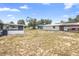 Expansive backyard with a screened-in porch, shed, and carport at 105 E Magnolia St, Davenport, FL 33837