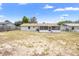 Spacious backyard featuring a screened-in porch, partially fenced and a well-maintained lawn at 105 E Magnolia St, Davenport, FL 33837