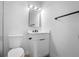Well-lit bathroom with a sleek white vanity, contemporary fixtures, and a clean, modern aesthetic at 105 E Magnolia St, Davenport, FL 33837