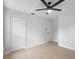 Bedroom features a ceiling fan, neutral walls, and a closet for storage at 105 E Magnolia St, Davenport, FL 33837
