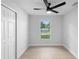 Bedroom features a closet, a ceiling fan, and a window view at 105 E Magnolia St, Davenport, FL 33837