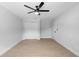 Clean, modern bedroom with a ceiling fan, wood-look floors, and a large closet at 105 E Magnolia St, Davenport, FL 33837