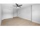 Neat bedroom with ceiling fan, wood-look floors, closet and door at 105 E Magnolia St, Davenport, FL 33837