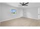 Bedroom with a ceiling fan, a window view, and vinyl flooring at 105 E Magnolia St, Davenport, FL 33837