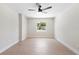 Bright bedroom with a modern ceiling fan, natural light, and fresh, neutral-toned paint at 105 E Magnolia St, Davenport, FL 33837