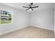 Bright bedroom featuring light walls, a modern fan, laminate floors, and a nice window view at 105 E Magnolia St, Davenport, FL 33837