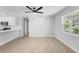 Dining room features wood-look flooring, a ceiling fan, and a view of the kitchen at 105 E Magnolia St, Davenport, FL 33837