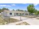 Inviting fenced home showcasing manicured yard, painted brick, and ample parking at 105 E Magnolia St, Davenport, FL 33837