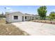 Charming single-story home with a paved driveway and well-maintained landscaping at 105 E Magnolia St, Davenport, FL 33837