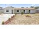 Charming single-story home featuring a tidy front yard with fresh landscaping and a brick exterior at 105 E Magnolia St, Davenport, FL 33837