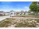 Charming single-story home with white painted brick, fenced yard, and a lush green lawn at 105 E Magnolia St, Davenport, FL 33837