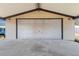 Large garage with concrete floor and awning providing shelter for vehicles and equipment at 105 E Magnolia St, Davenport, FL 33837