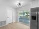 Eat in kitchen with access to the back patio and featuring modern stainless steel appliances at 105 E Magnolia St, Davenport, FL 33837