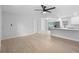 Bright, open-concept living room featuring modern flooring and a seamless flow into the kitchen at 105 E Magnolia St, Davenport, FL 33837