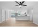 Bright, open-concept living space featuring sleek floors and a modern white kitchen with stainless steel appliances at 105 E Magnolia St, Davenport, FL 33837