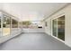 Covered patio features neutral colors, gray flooring, and screens for enjoying the outdoors at 105 E Magnolia St, Davenport, FL 33837