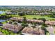 An aerial shot displays townhomes on a golf course with water views in the distance at 10653 Belfry Cir, Orlando, FL 32832