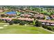 Aerial view of the golf course community with condos and ponds on a bright day at 10653 Belfry Cir, Orlando, FL 32832