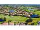 Community aerial view features lush golf course, water features, and townhome-style living at 10653 Belfry Cir, Orlando, FL 32832