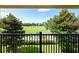 Balcony overlooking a lush green golf course with mature trees and blue sky at 10653 Belfry Cir, Orlando, FL 32832