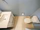 Overhead view of a bathroom showcasing a toilet, sink, vanity, and beige tile flooring at 10653 Belfry Cir, Orlando, FL 32832