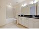 Bathroom featuring double vanity, garden tub and shower combo at 10653 Belfry Cir, Orlando, FL 32832
