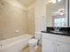 Bathroom featuring neutral tile and granite countertops at 10653 Belfry Cir, Orlando, FL 32832