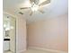 This bedroom has a ceiling fan and an ensuite bathroom at 10653 Belfry Cir, Orlando, FL 32832