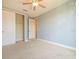 This bedroom has plush carpet, neutral walls and ceiling fan at 10653 Belfry Cir, Orlando, FL 32832