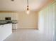 Bright dining area adjacent to the kitchen with sliding glass doors and tile flooring at 10653 Belfry Cir, Orlando, FL 32832