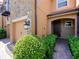 Welcoming home entrance with lush landscaping, stone accents, and covered entry way at 10653 Belfry Cir, Orlando, FL 32832