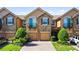 Beautiful townhomes featuring brick paver driveway, stone accents, and Mediterranean-style architecture at 10653 Belfry Cir, Orlando, FL 32832