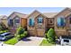 Charming townhomes featuring stone accents, a private garage, and manicured landscaping at 10653 Belfry Cir, Orlando, FL 32832