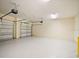 Spacious three car garage with white walls and sealed concrete flooring at 10653 Belfry Cir, Orlando, FL 32832