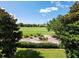 Scenic golf course view from a porch with green grass, trees, and blue sky at 10653 Belfry Cir, Orlando, FL 32832