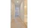 Hallway with beige carpet leads past a doorway to the bathroom at 10653 Belfry Cir, Orlando, FL 32832