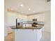 Modern kitchen featuring white cabinets, stainless steel appliances, and a breakfast bar at 10653 Belfry Cir, Orlando, FL 32832