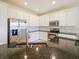 Well-lit kitchen boasts stainless steel appliances, granite countertops, and white cabinets at 10653 Belfry Cir, Orlando, FL 32832