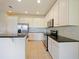 Well-equipped kitchen featuring stainless steel appliances and white cabinets at 10653 Belfry Cir, Orlando, FL 32832