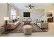 Cozy living room featuring neutral decor, large windows, and a ceiling fan at 10653 Belfry Cir, Orlando, FL 32832