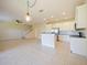 Spacious living space with kitchen, staircase, tile floors, and modern lighting at 10653 Belfry Cir, Orlando, FL 32832