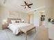 Main bedroom featuring a neutral color palette, tray ceiling, and large bed at 10653 Belfry Cir, Orlando, FL 32832