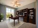Office featuring custom built-in shelving and a desk with backyard view at 10653 Belfry Cir, Orlando, FL 32832