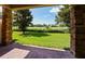 Outdoor patio view of a pristine golf course with green grass and blue sky at 10653 Belfry Cir, Orlando, FL 32832