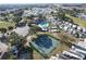 An aerial view of the community featuring a pool, tennis courts, parking, and residences at 1115 Deer Creek Blvd, Davenport, FL 33837